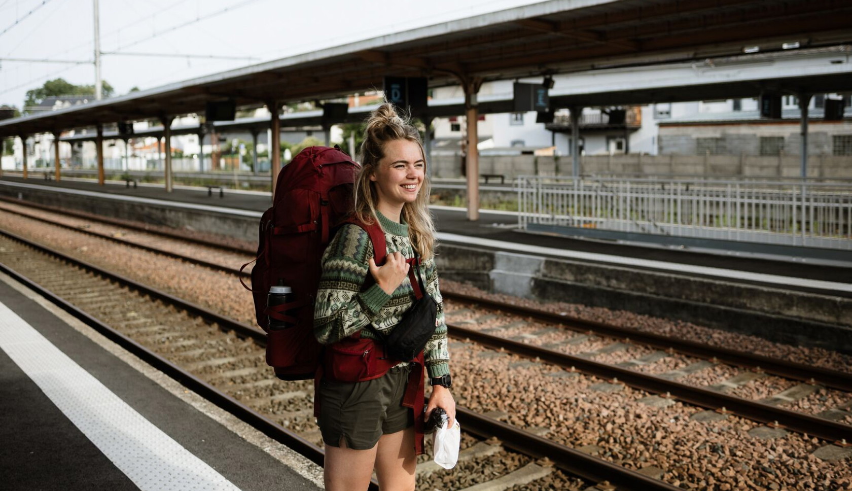 Girl waiting at the station with her rucksack