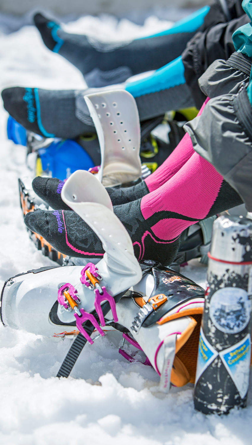 Person wearing Bridgedale socks sitting in the snow