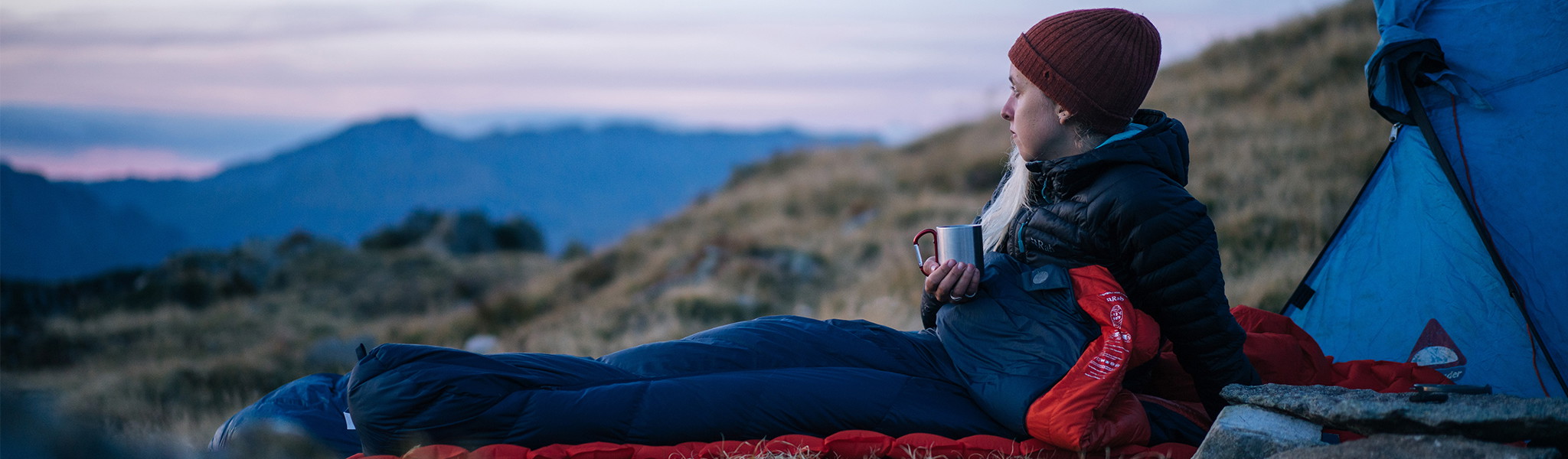 A person wrapped up in a bright blue sleeping bag