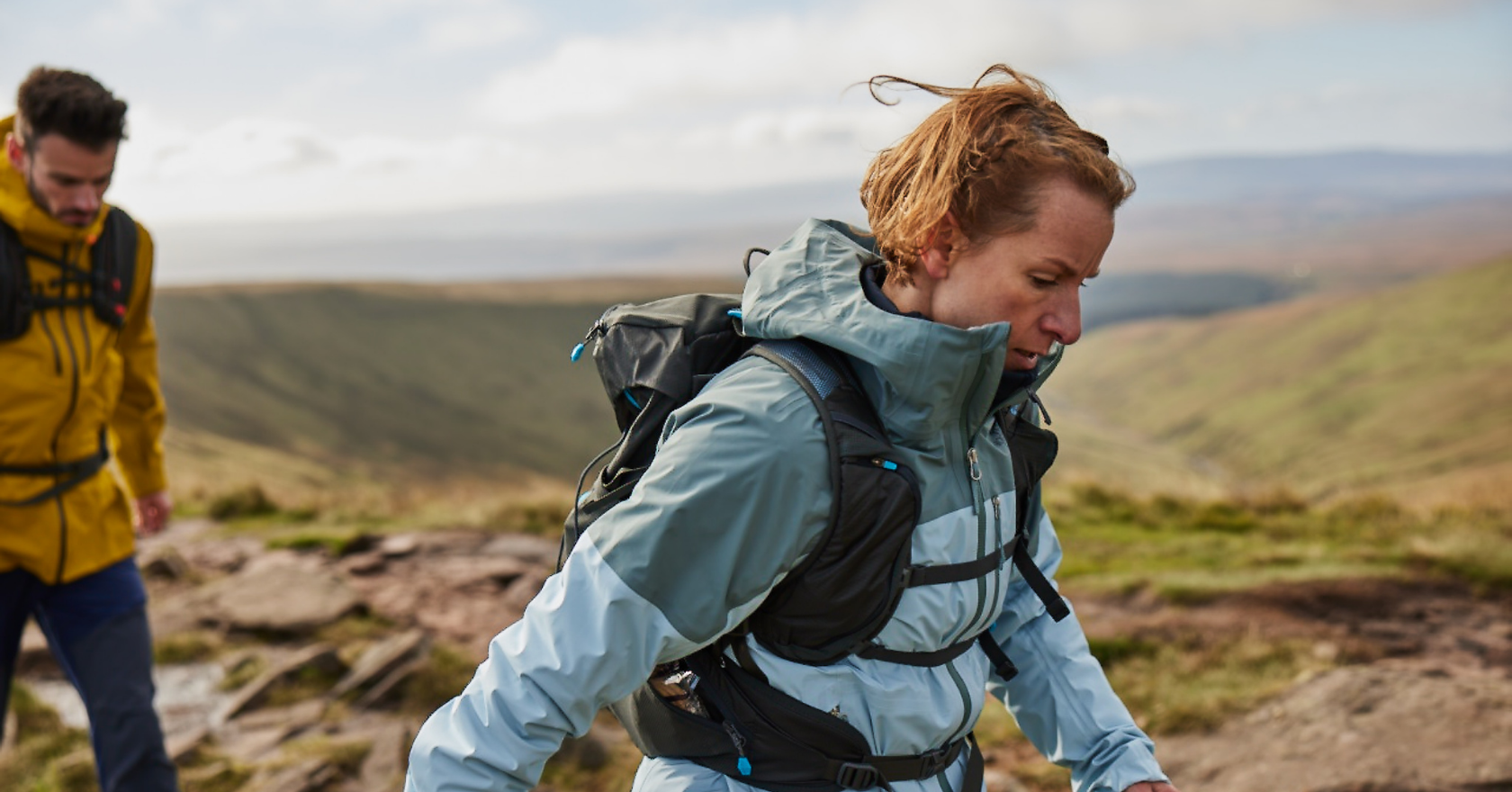 Two people on a hike wearing waterproof jackets 