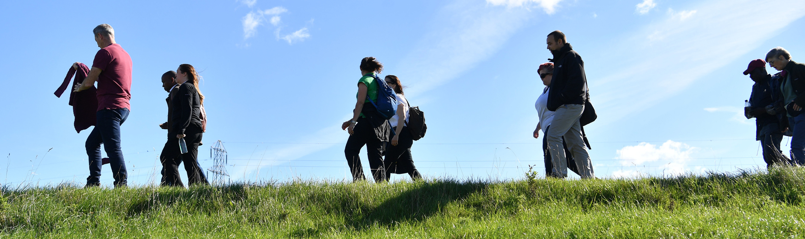 People walking together over a hill