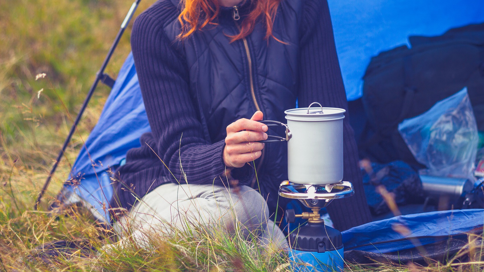 Woman warming her food in a stove