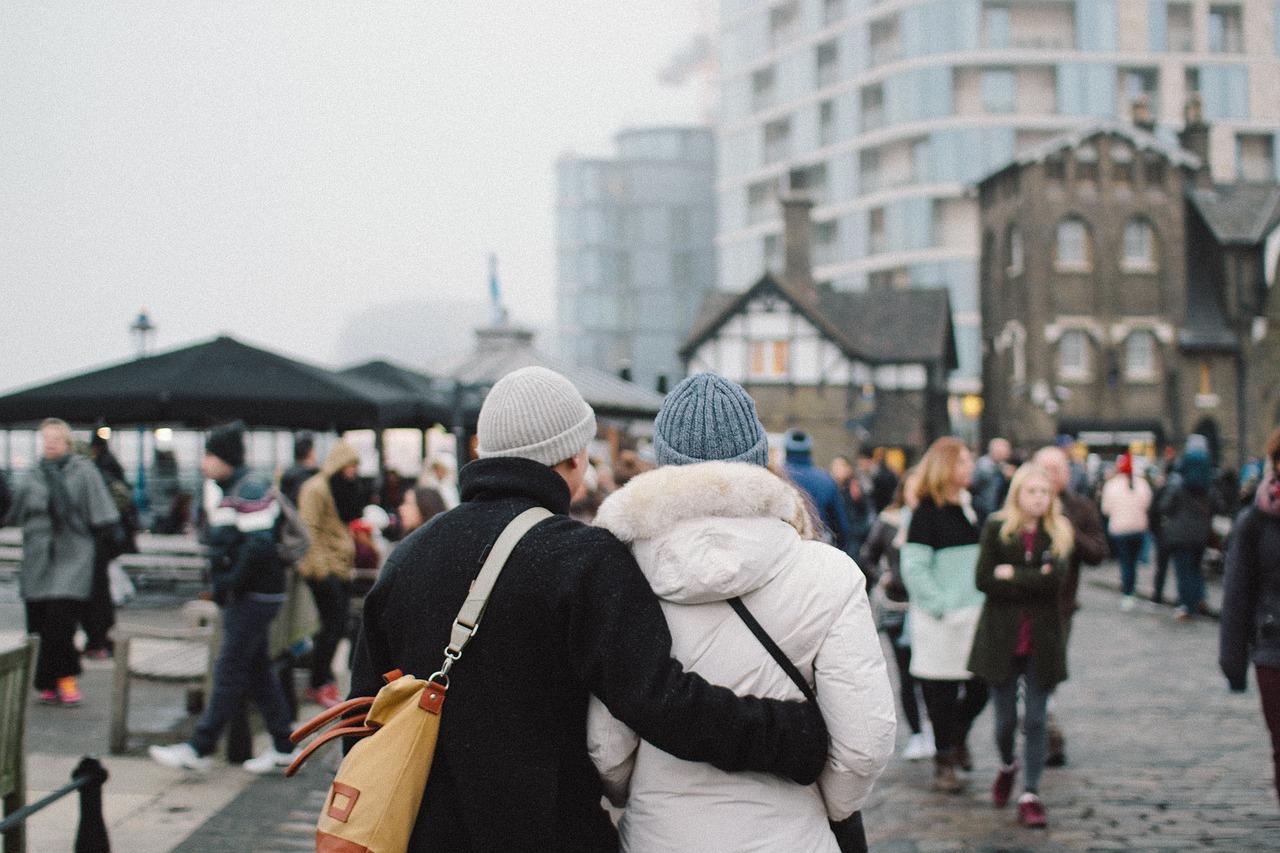 A couple wearing beanie hats in the winter 