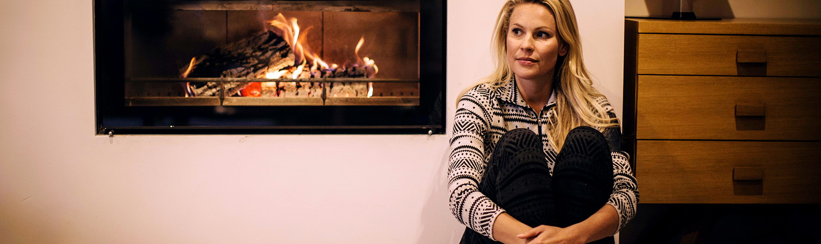 A woman wearing a base layer in a ski chalet 